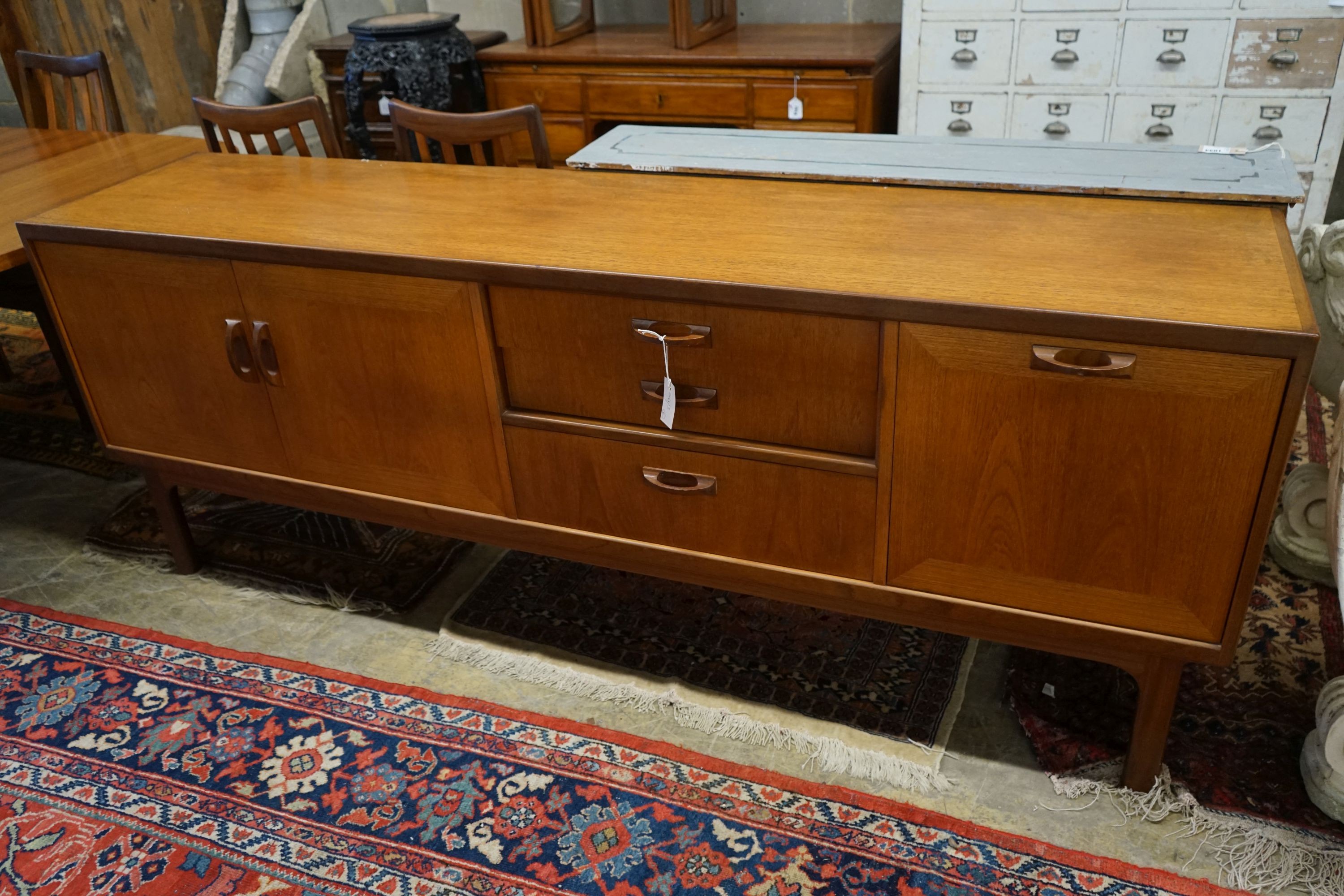 A G Plan teak dining suite comprising extending table, 158cm extended, width 112cm, height 72cm, four chairs and a sideboard